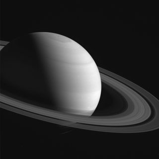 A close-up view of Saturn with rings shadowing the planet's southern hemisphere