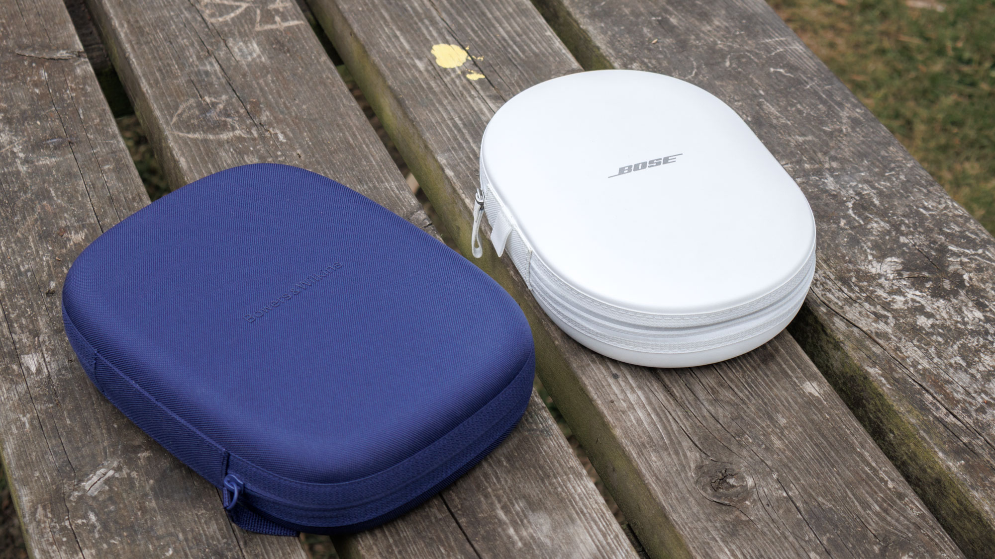 Bowers & Wilkins Px7 S3 vs Bose QuietComfort Ultra Headphones cases on a wooden surface