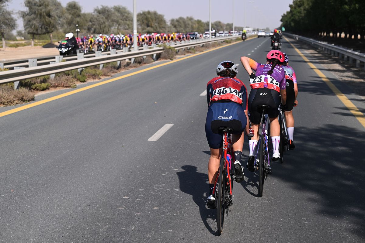 The breakaway passing the peloton on the other side of the road