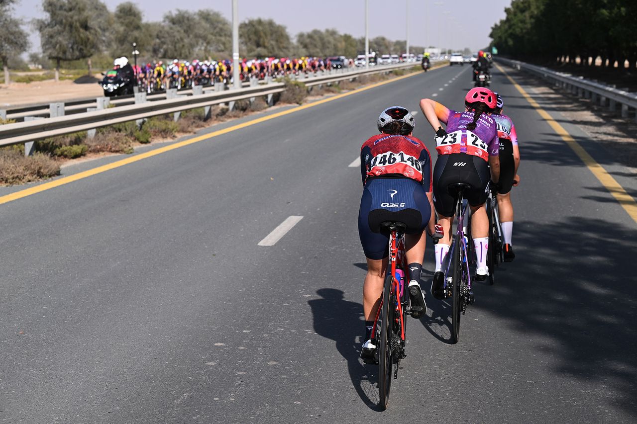 The breakaway passing the peloton on the other side of the road