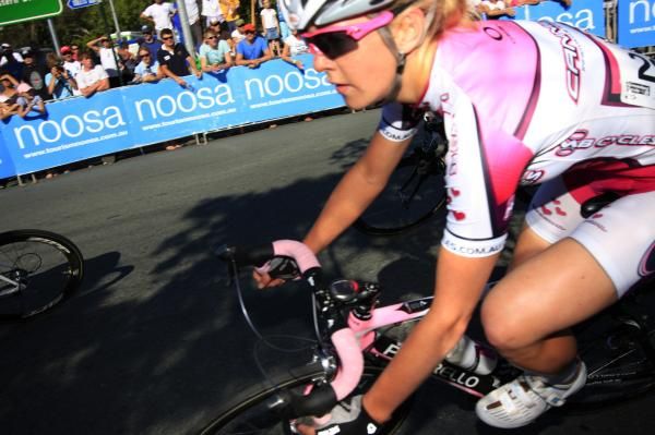 A competitor in the elite women's race corners fast by herself.