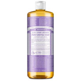 A clear bottle of Dr. Bronner's castile soap with white lid and purple and white label