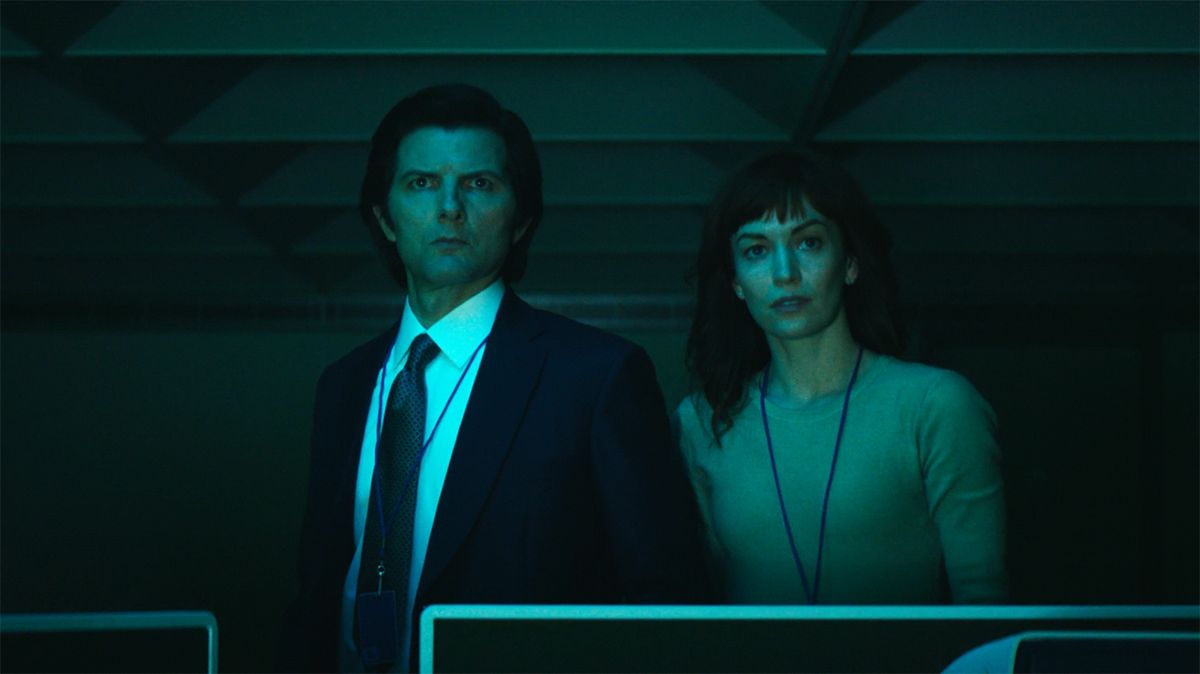 Mark S and Helly R standing by their desks bathed in blue light in Severance&#039;s season 2 finale