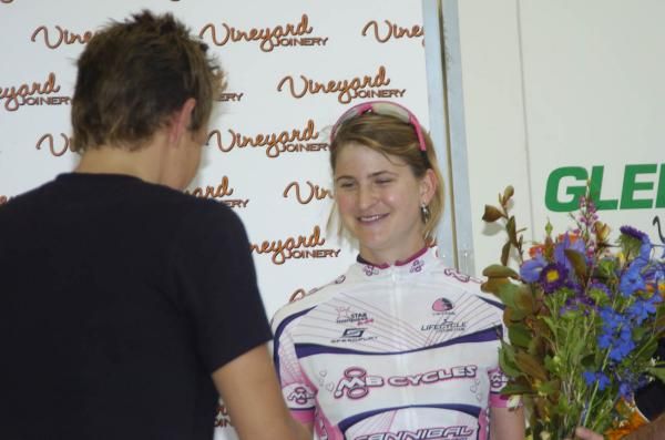 Heinrich Haussler presented women's winner Loren Rowney with her flowers.