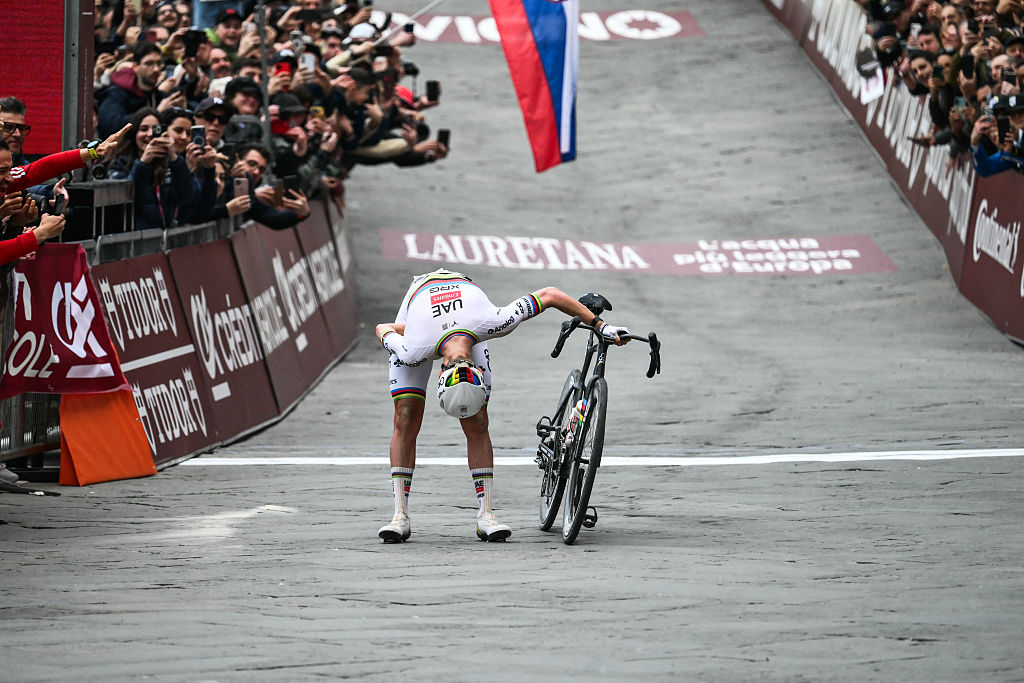 UAE Team Emirates's Slovenian Tadej Pogacar celebrates as he crosses the line to win the 20th one-day classic 'Strade Bianche' (White Roads) men's cycling race between Siena and Siena in Tuscany on March 7, 2026. (Photo by Marco BERTORELLO / AFP)
