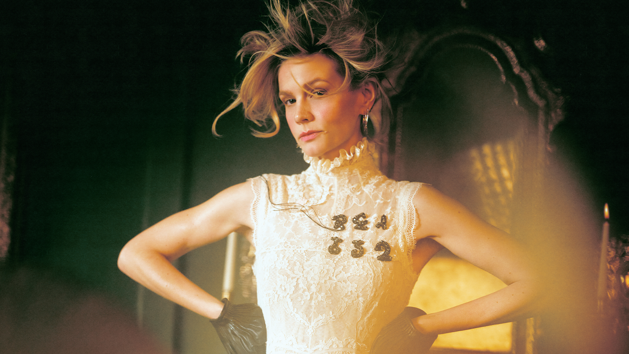 Carey Mulligan for Who What Wear's April cover story wearing a white lace dress with black lettering on the left chest area and black gloves