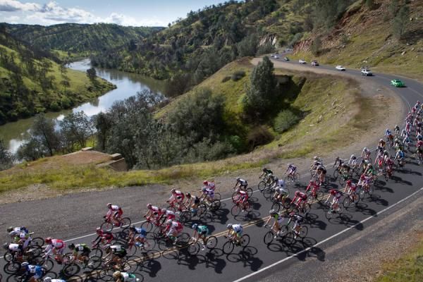 Men's elite field rolls out on first of six laps of the MID (Merced Irrigation District) Road Race alongside the Merced River.