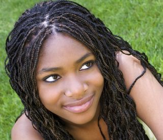 A young woman with braids in her hair.