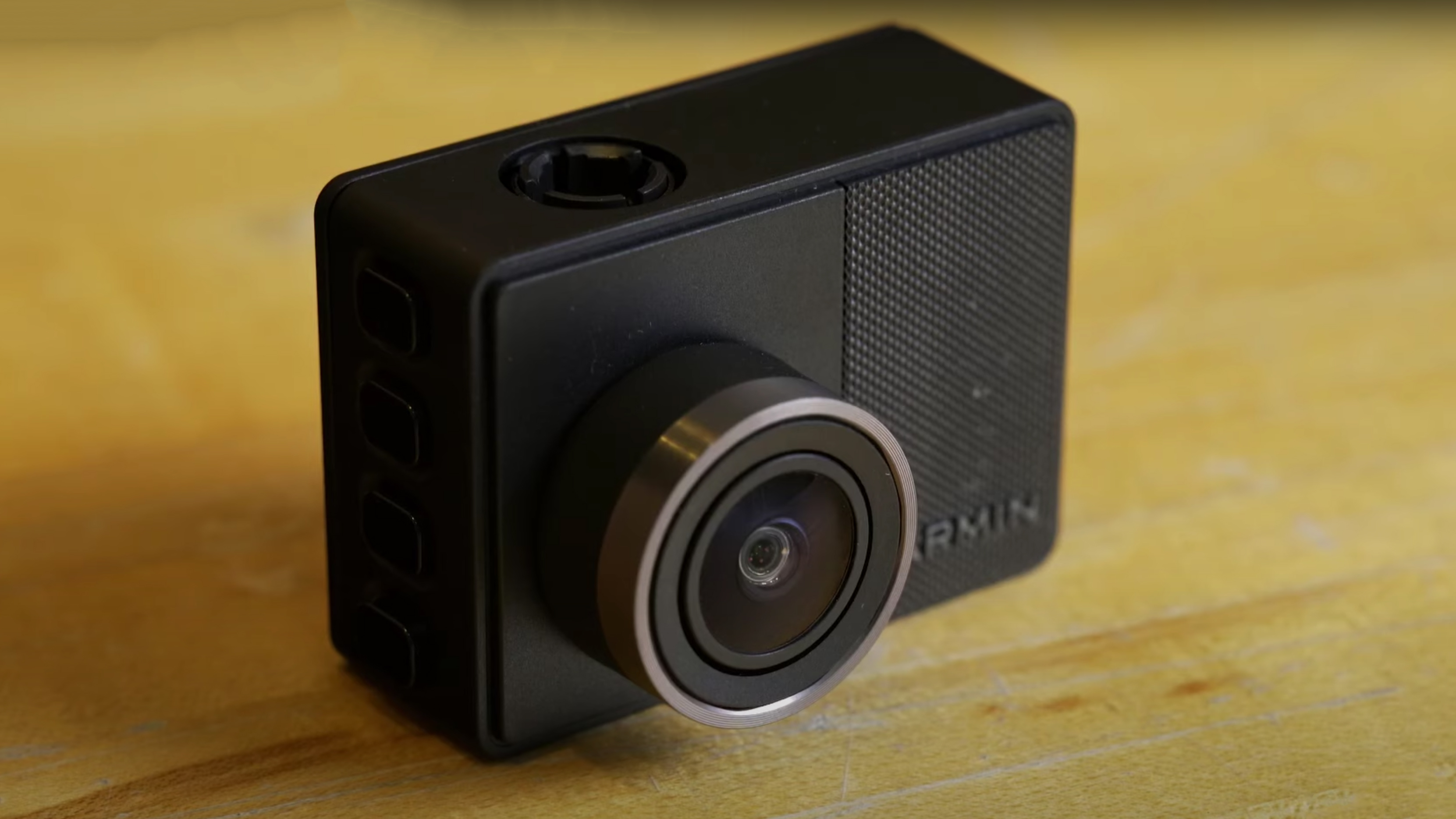 The Garmin Dash Cam 67W on a wooden table