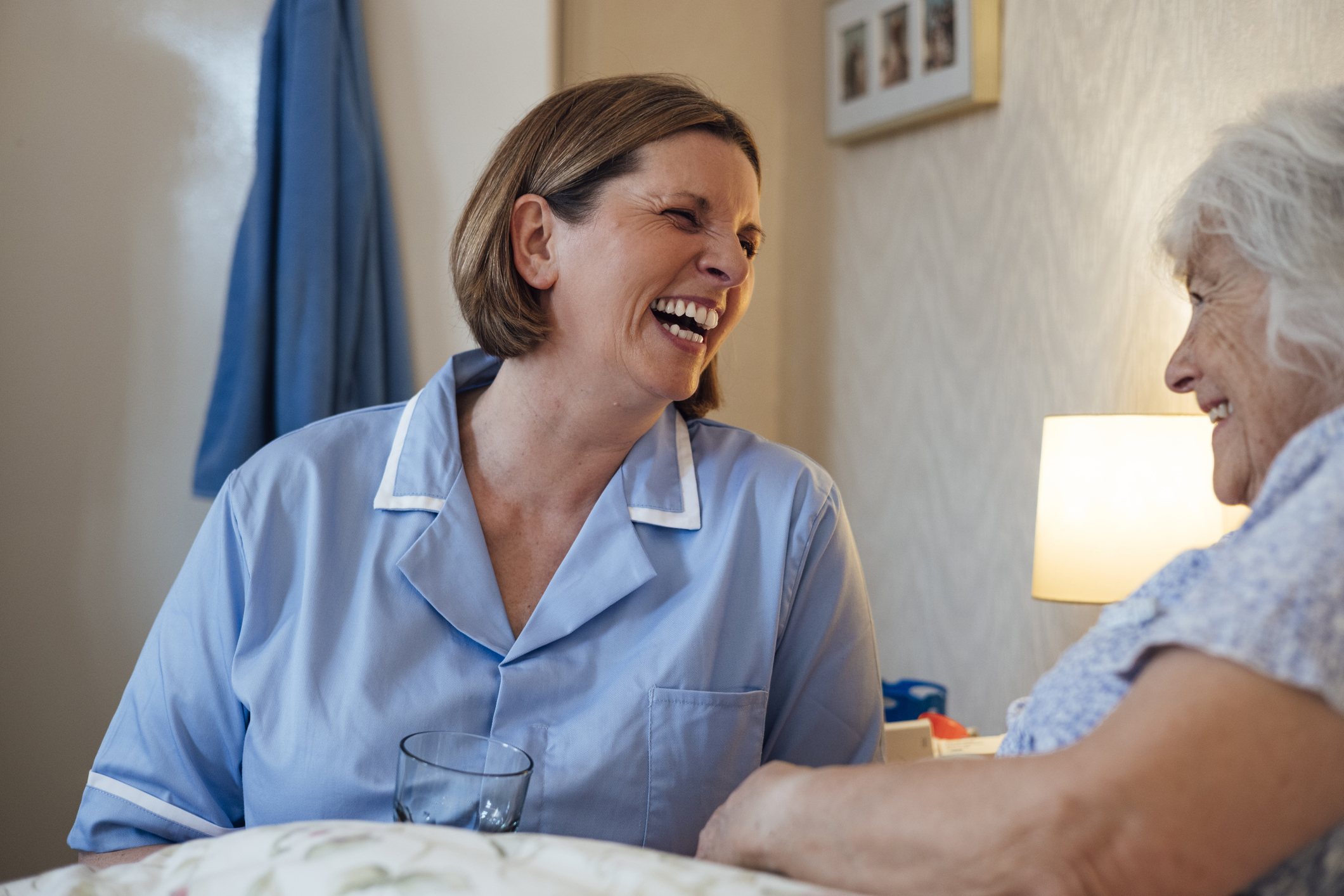 Nurse laughing with older patient