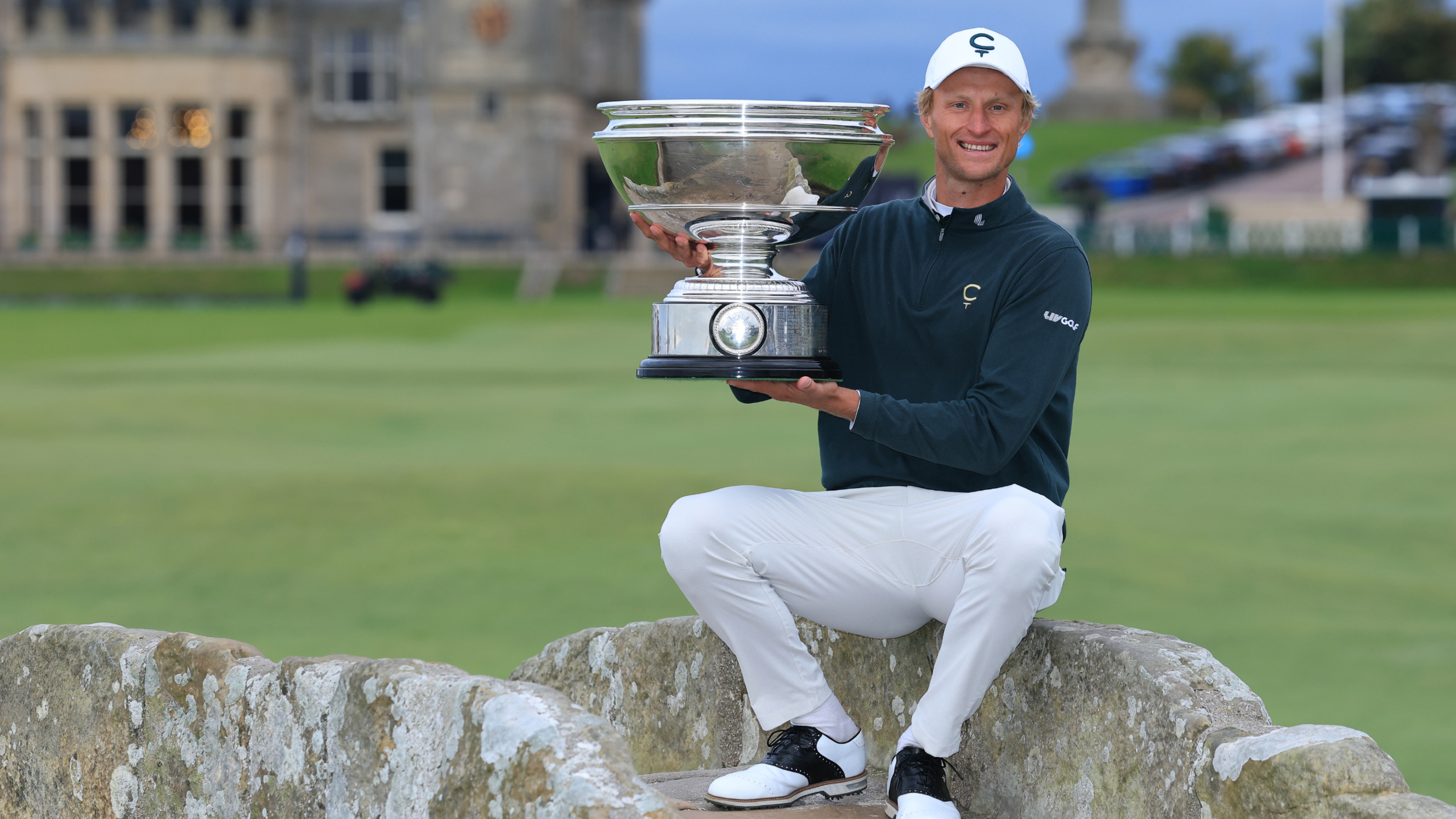 Adrian Meronk on the Swilcan Bridge with the Alfred Dunhill Links Championship trophy  