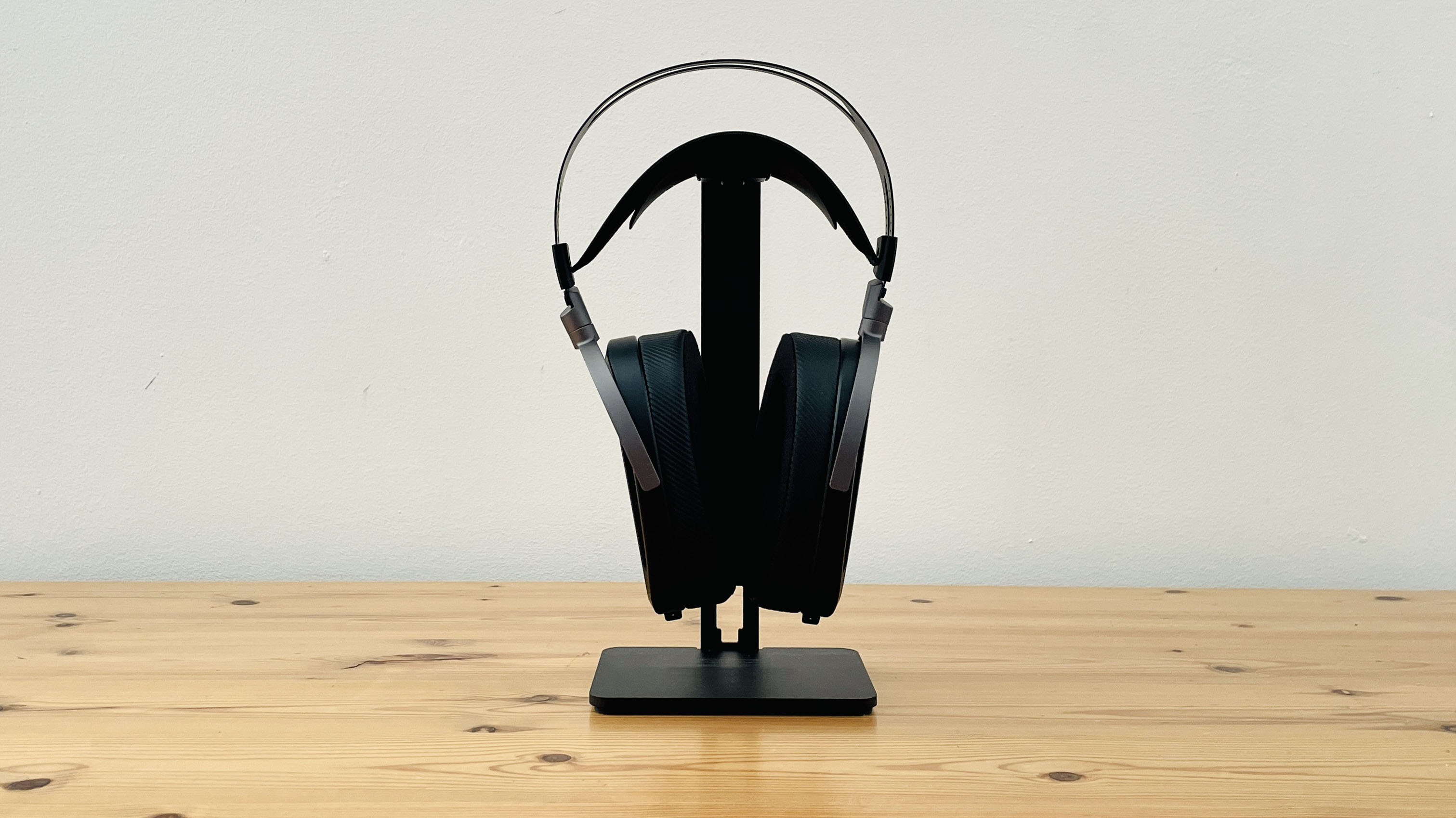 A picture of the Asus ROG Kithara audiophile wired gaming headset on a wooden surface.