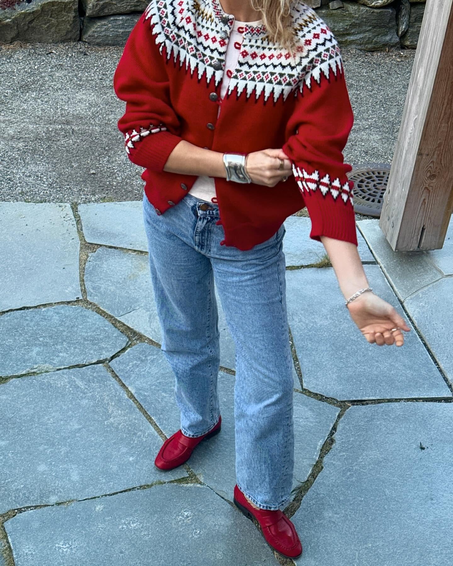 Influencer @lucywilliams02 wears a fairisle cardigan and jeans and red loafers.