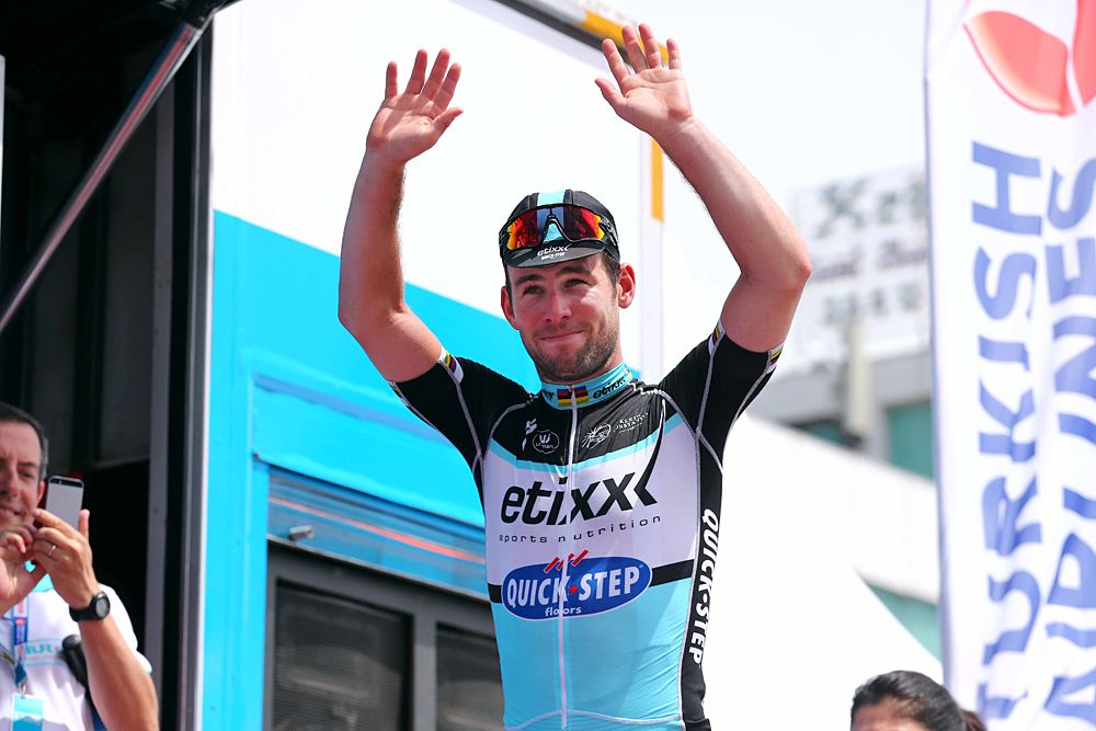 Mark Cavendish (Etixx-QuickStep) walks onto the podium as the day's stage winner