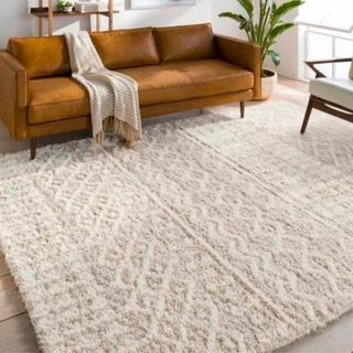 Cream geometric rug with leather sofa 