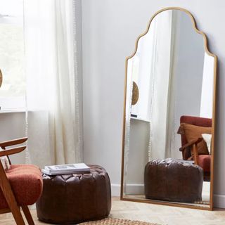 Dunelm mirror standing in room with sofa opposite 
