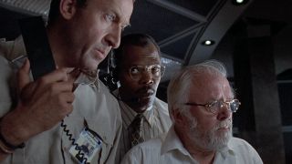 Bob Peck, Samuel L. Jackson, and Richard Attenborough stand around in the control room in Jurassic Park.