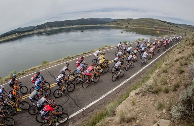 The peloton passes by a lake along today's stage.