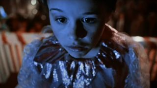 Danielle Harris wears a costume lit by a TV's glow in Halloween 5: The Revenge of Michael Myers.