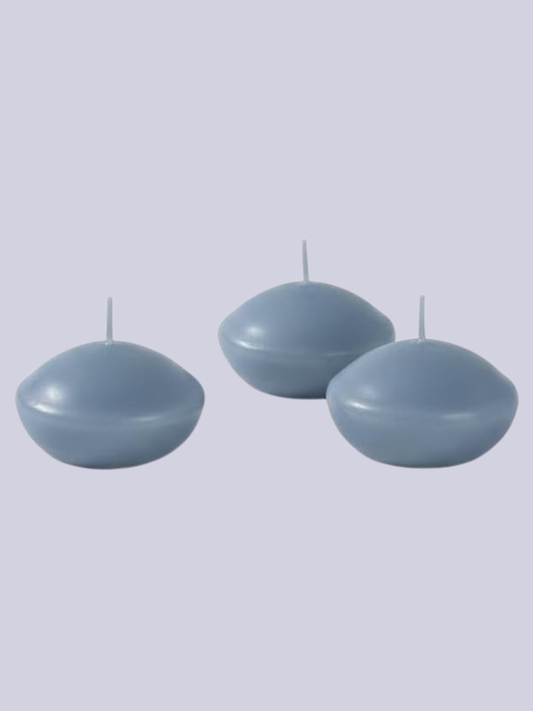 A set of three dusty blue floating candles