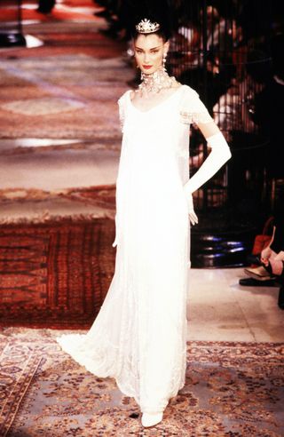 a model on the Givenchy Couture runway in 1997 wearing a my fair lady inspired gown