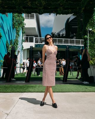 Kendall Jenner attends the Miami Grand Prix in a gingham dress by Tommy Hilfiger