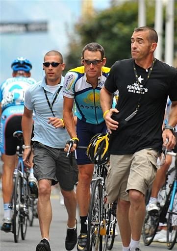 Lance Armstrong is escorted to the start line.