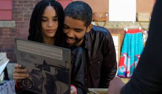 High Fidelity Zoe Kravitz checks out a record, with a guy over her shoulder