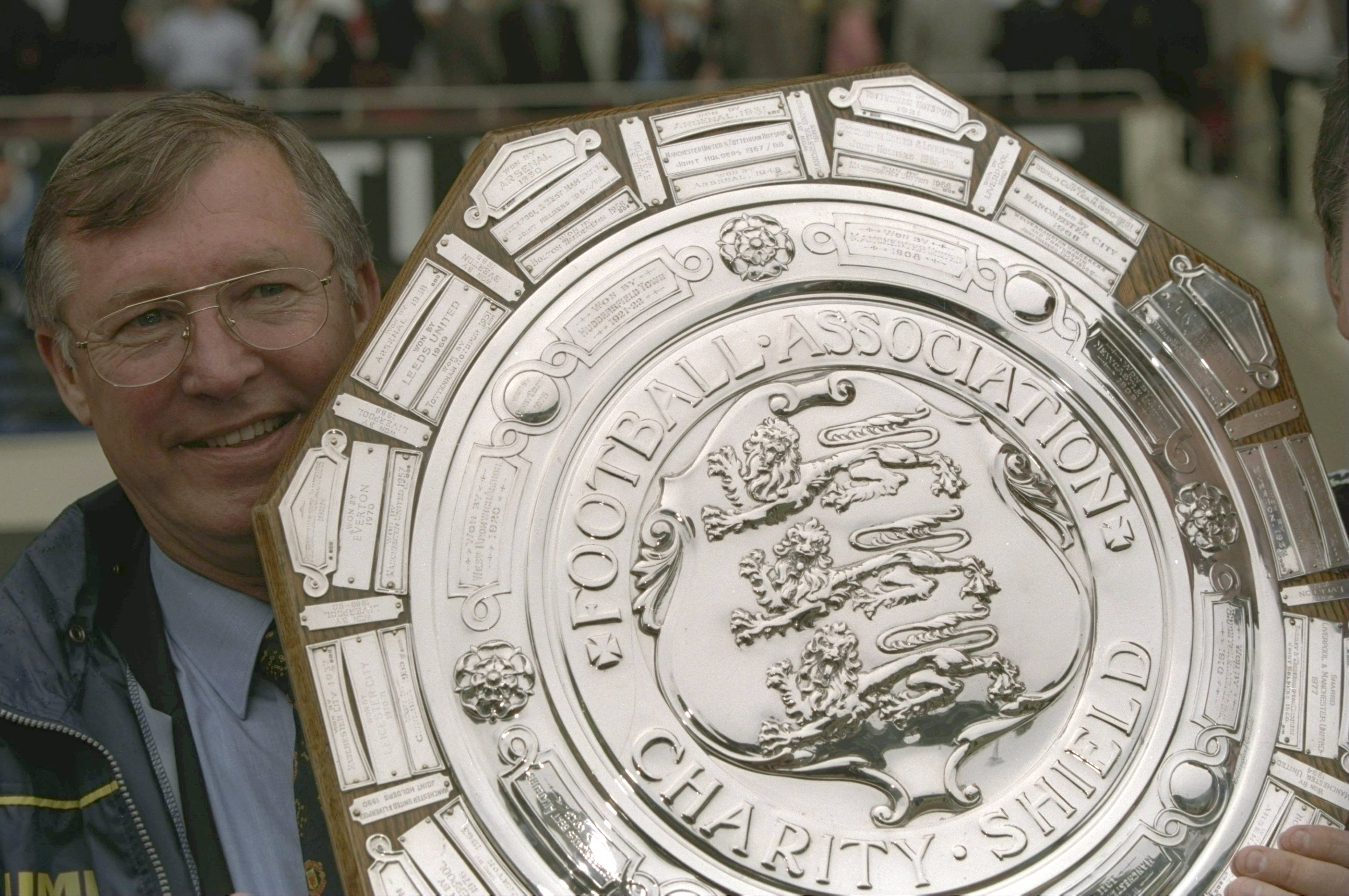 Alex Ferguson holds the Charity Shield after Manchester United's win over Chelsea on penalties in August 1997.