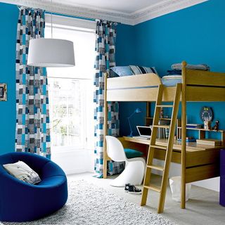 childrens room with wooden bed and a desk below