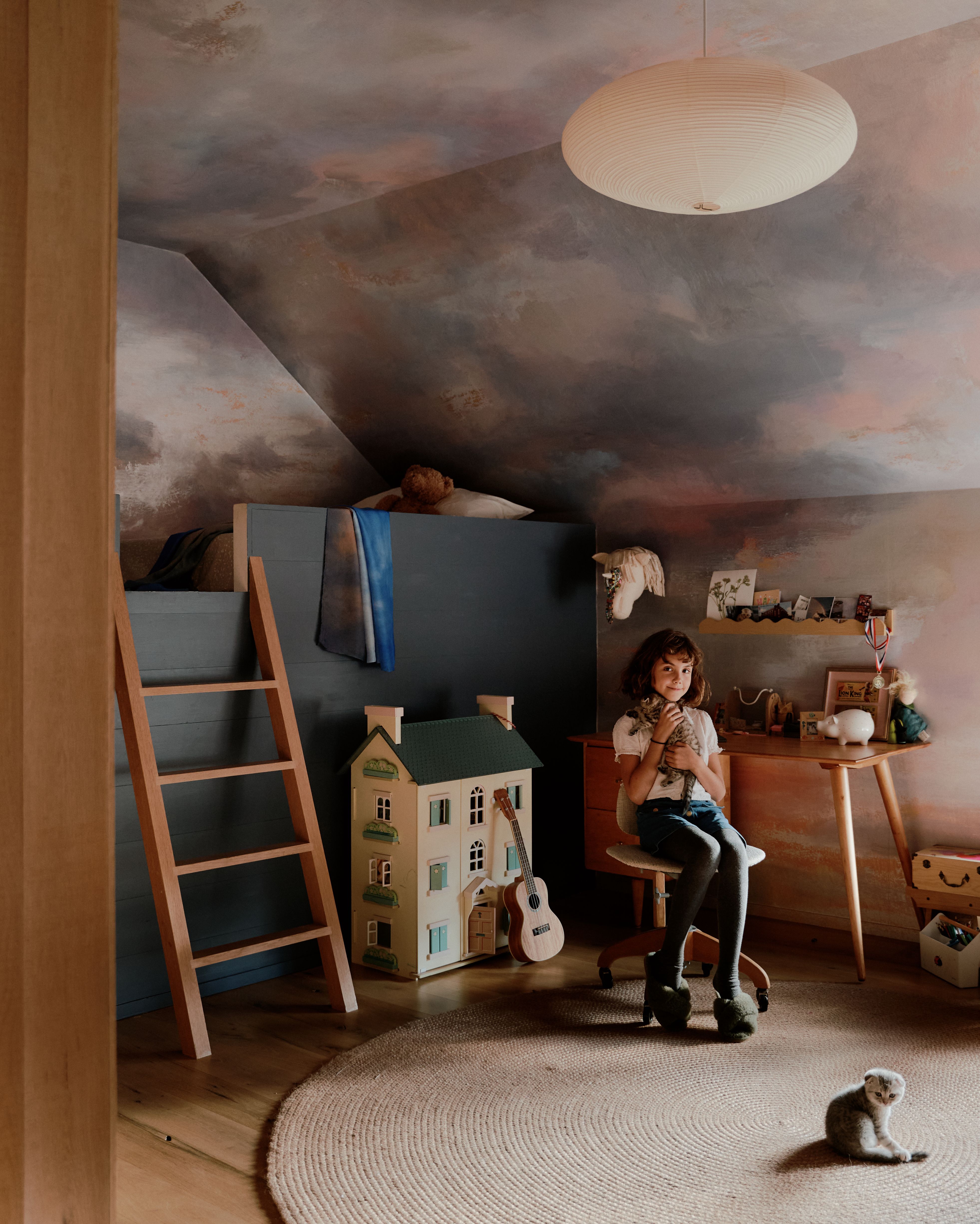 The children's rooms upstairs are covered with playful wallpapers on walls and ceiling, making the rooms into small worlds of their own. 