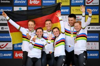 BRUGES BELGIUM SEPTEMBER 22 LR Gold medalists Nikias Arndt of Germany Lisa Brennauer of Germany Tony Martin of Germany Lisa Klein of Germany Max Walscheid of Germany and Mieke Kroger of Germany with world champion jerseys celebrate on the podium while holding the flag of they country during the medal ceremony after the 94th UCI Road World Championships 2021 Team Time Trial Mixed Relay a 445km race from KnokkeHeist to Bruges the day cyclist Tony Martin of Germany withdraws from professional cycling flanders2021 TT on September 22 2021 in Bruges Belgium Photo by Tim de WaeleGetty Images