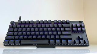 The SteelSeries Apex Pro Gen 3 TKL on a stand on a white table