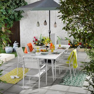 Patio with dingin table and chairs set with parasol