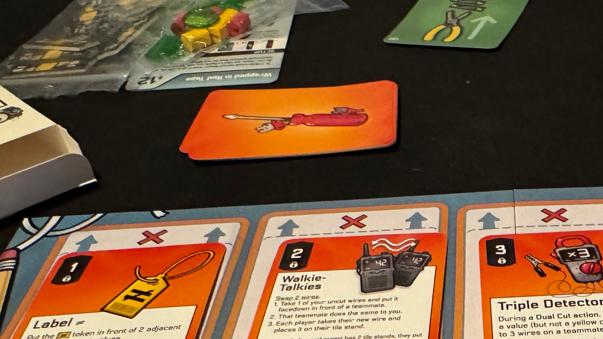 Cards and tokens laid out on a black surface