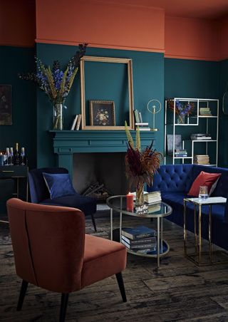 blue living room with a painted deep orange ceiling and rich velvet furniture