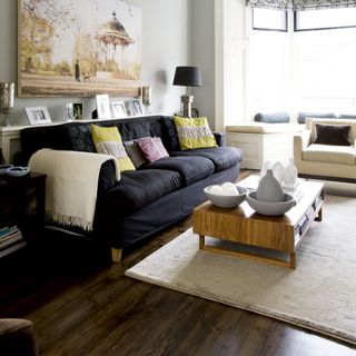 Living room with dark wooden floors and beige rug