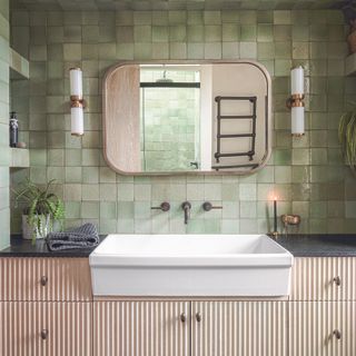 Bathroom with green natural tiles on walls