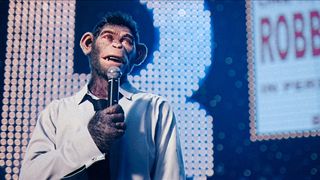 CG-animated chimpanzee Robbie Williams on-stage during a concert in Michael Gracey's "Better Man".