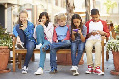A group of children using their phones