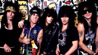 LA Guns standing in front of a graffiti-covered wall