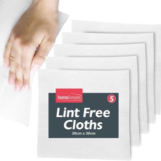 An image of cut-outs of white lint cloths with a hand using picking up one