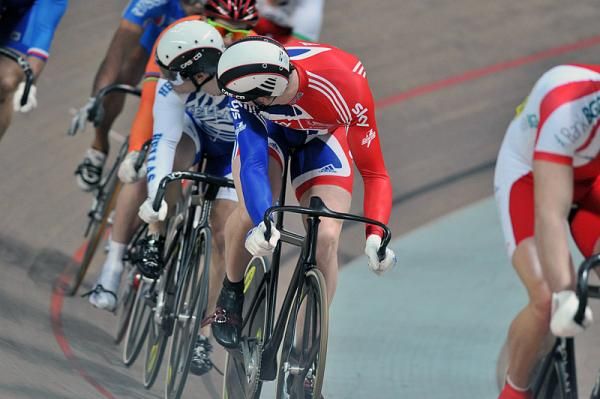 Matthew Crampton (Great Britain) and Zafeiris Volikakis (Greece) check on the position of their rivals in their first round keirin heat.