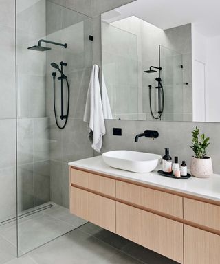 grey modern bathroom with shower and large sink unit