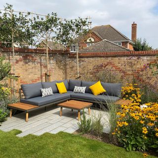 grey outdoor sofa with yellow cushions