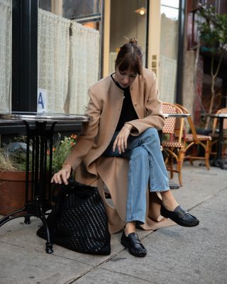 Easy winter outfits: @lizzyhadfield wears a camel coat with blue jeans and loafers