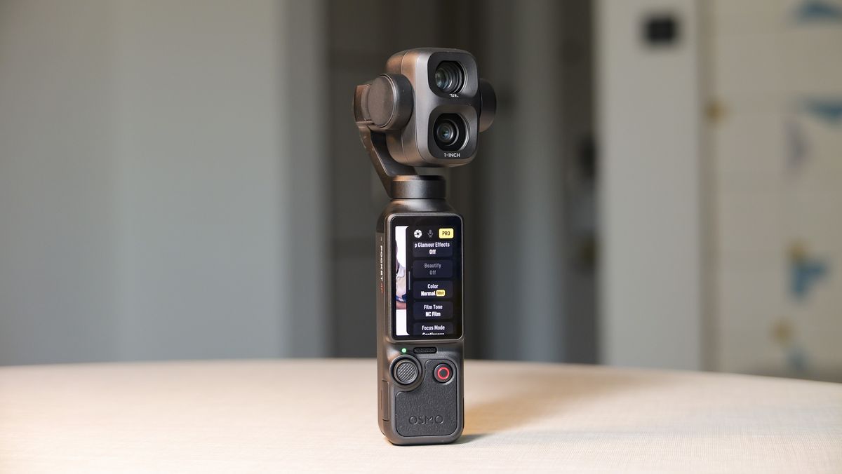 DJI Osmo Pocket 4P vlogging camera on a white desk in modern room