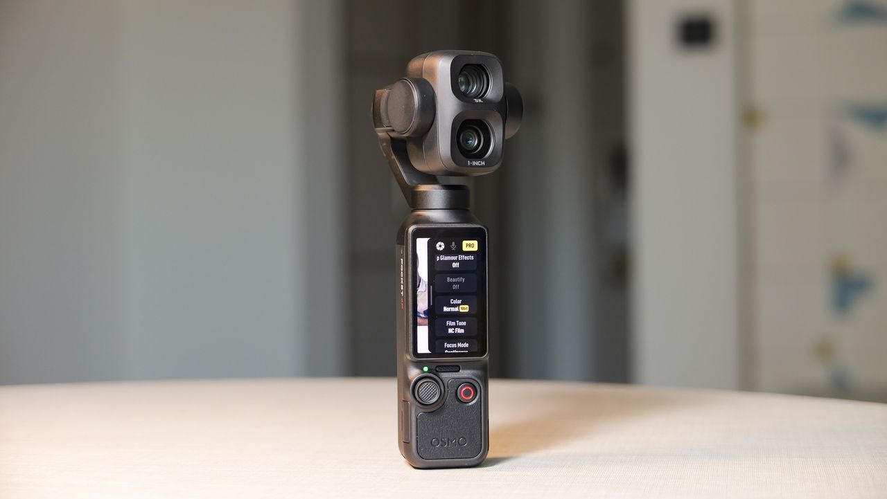 DJI Osmo Pocket 4P vlogging camera on a white desk in modern room