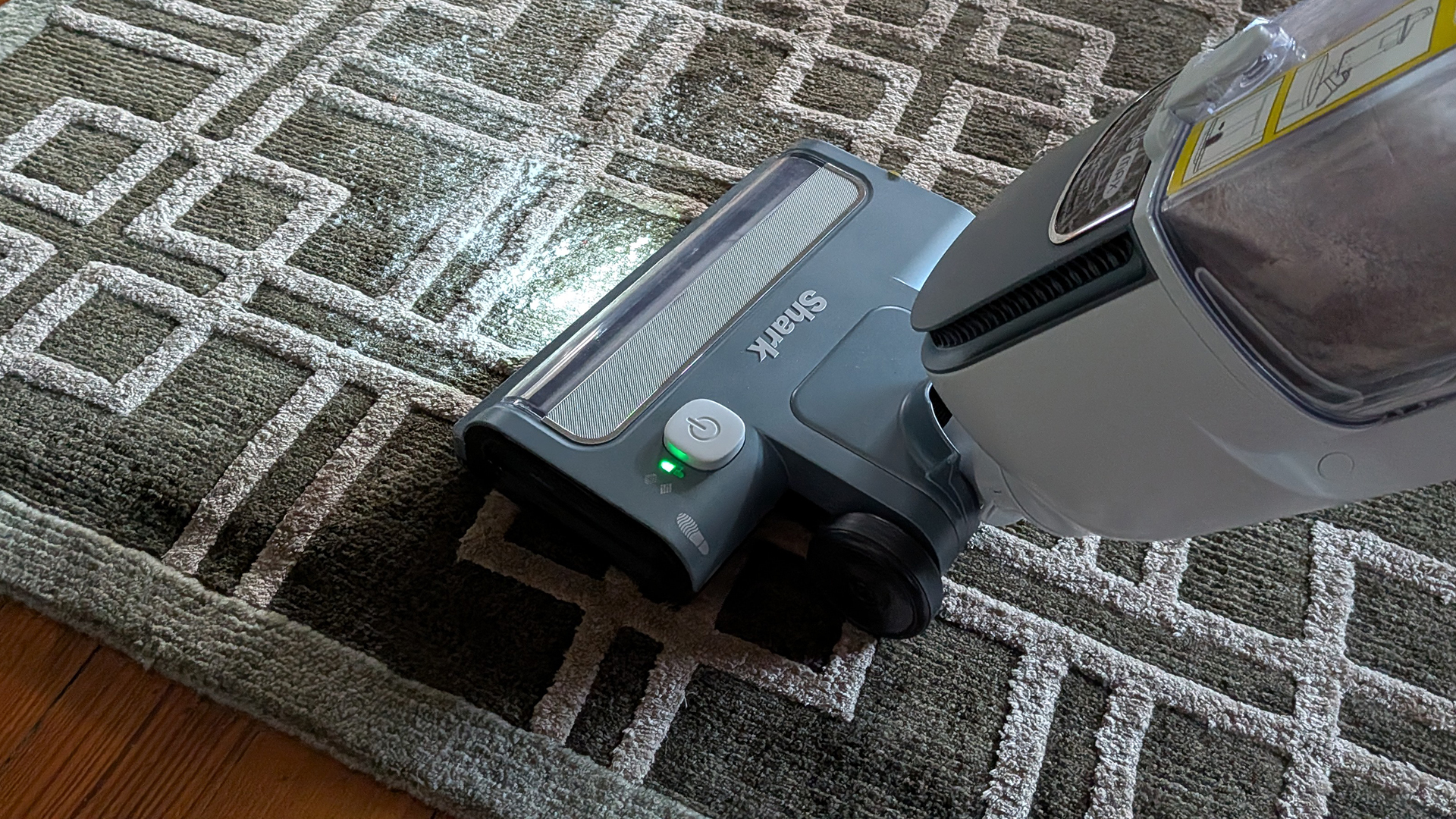 Tester using the Shark Freestyle Max cordless upright vacuum to clear flour from a carpet rug