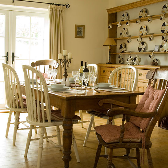 dining room with cream wall and shelf on wall with dining table and chairs